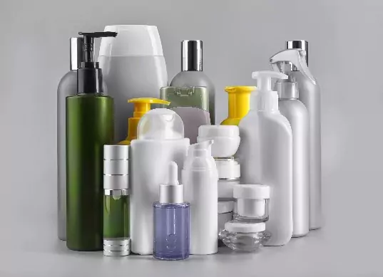 An assortment of personal care products on a grey background